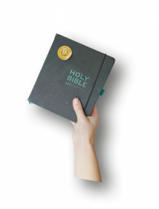 Hand holding up a Bible with the Bible Buddy Sticker on it