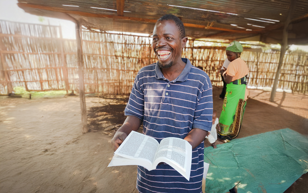 Man smiling with an open Bible in Malawi